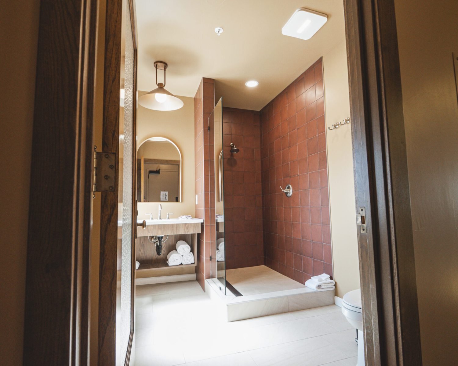 the-abbott-suite-bathroom-entrance-and-shower-view-powerhouse-on-broadway