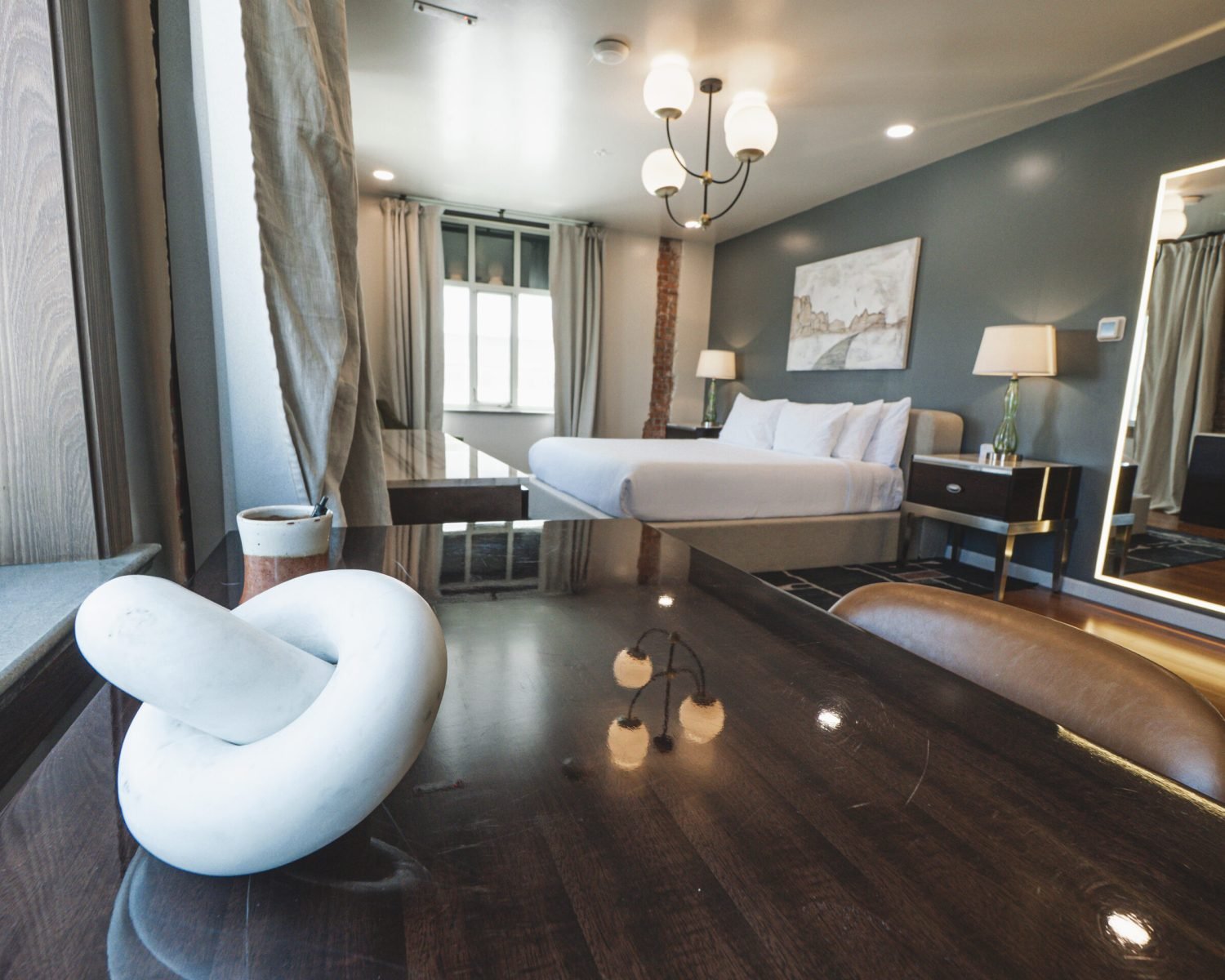 the-everett-suite-desk-to-bed-view-with-modern-decor-and-large-mirror-powerhouse-on-broadway