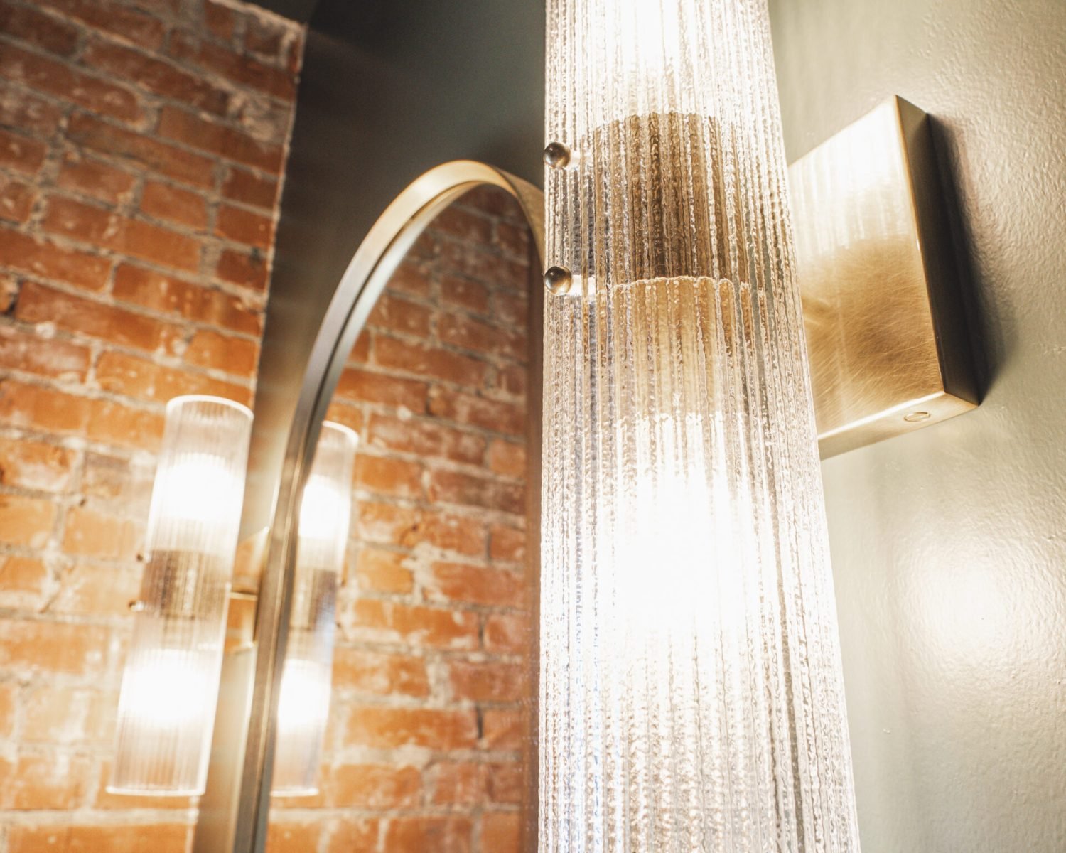 the-ford-suite-bathroom-glass-sconce-lighting-and-brick-wall-detail-powerhouse-on-broadway