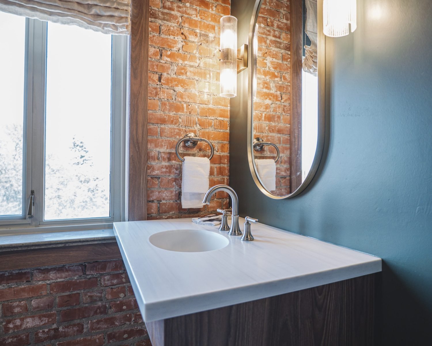 the-ford-suite-bathroom-sink-with-brick-wall-and-sconce-lighting-powerhouse-on-broadway
