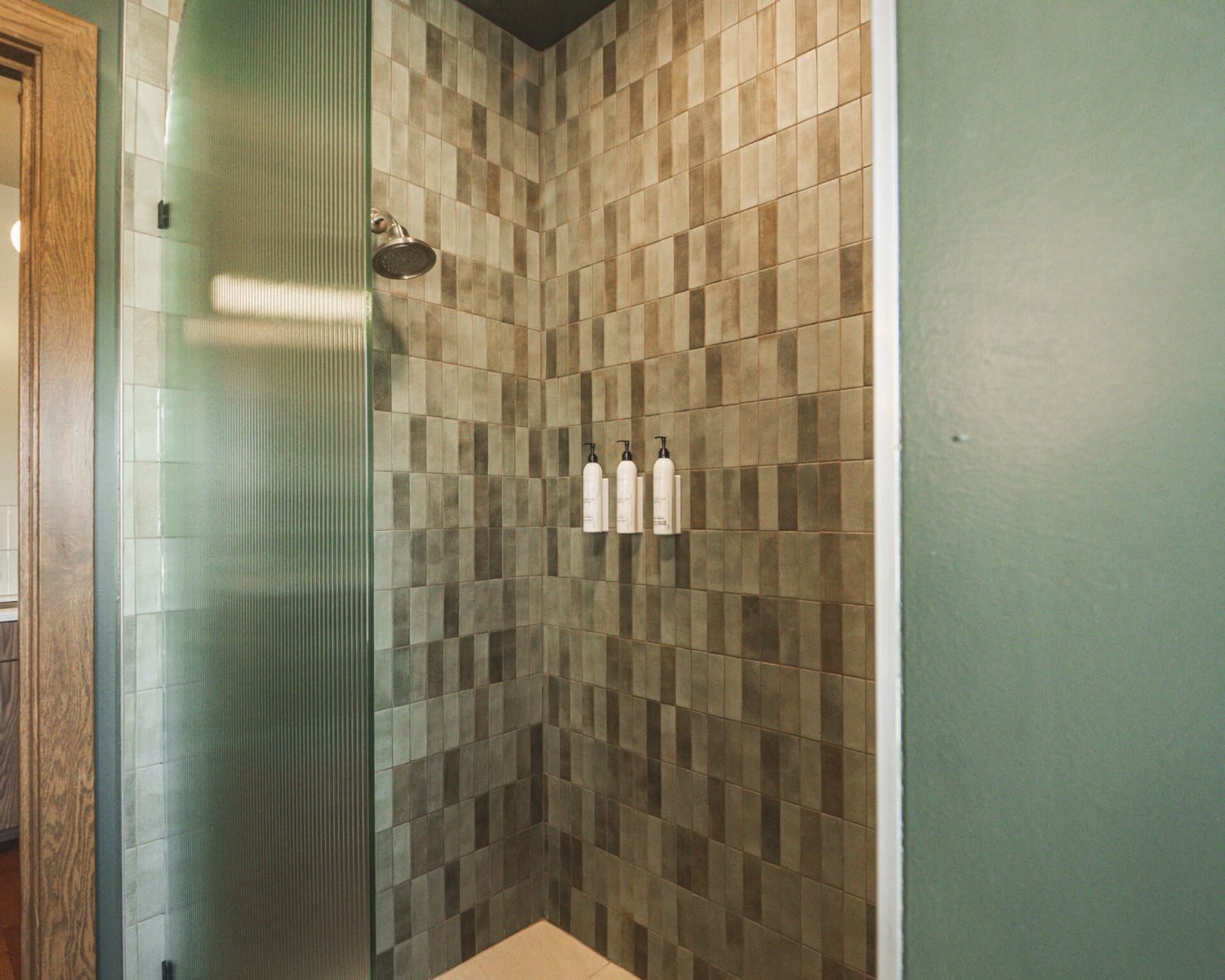 the-ford-suite-bathroom-tiled-shower-green-walls-modern-lighting-powerhouse-on-broadway