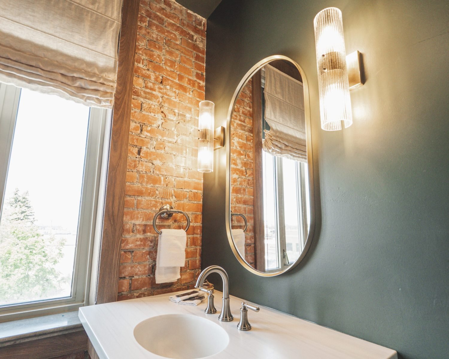 the-ford-suite-bathroom-vanity-brick-window-green-walls-modern-lighting-powerhouse-on-broadway