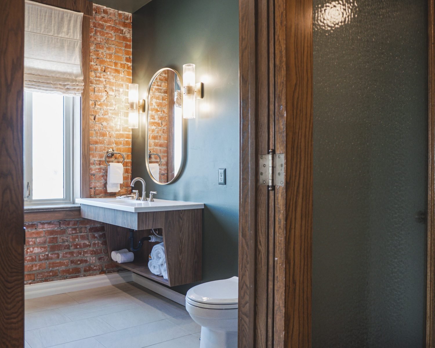 the-ford-suite-bathroom-with-exposed-brick-vanity-and-modern-lighting-powerhouse-on-broadway