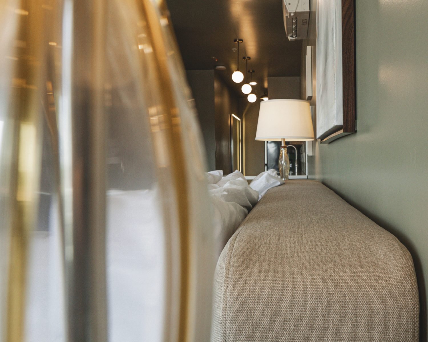 the-ford-suite-bedside-glass-lamp-closeup-hallway-lighting-soft-green-walls-powerhouse-on-broadway