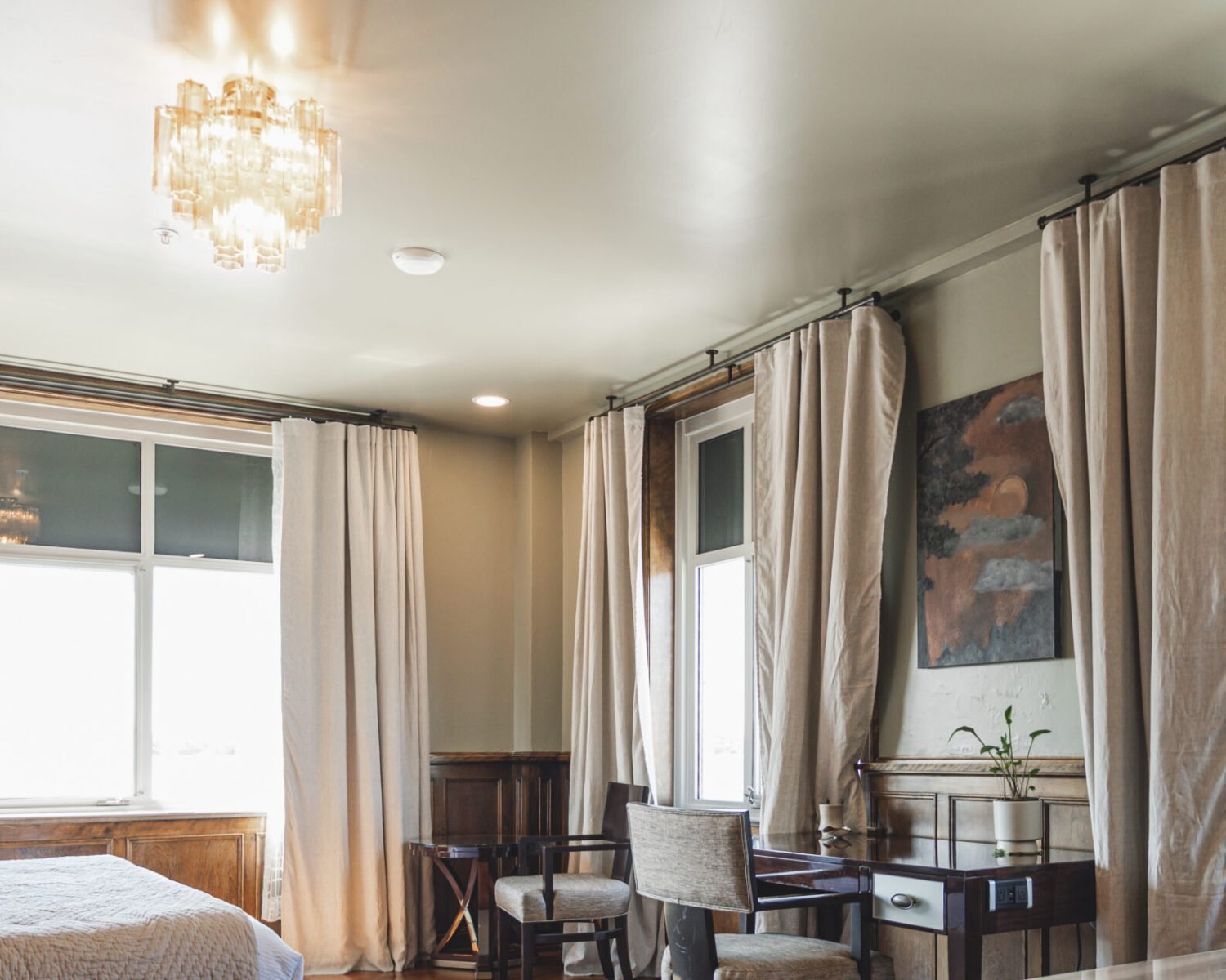 the-ford-suite-desk-area-large-windows-drapes-crystal-chandelier-and-wall-artwork-powerhouse-on-broadway