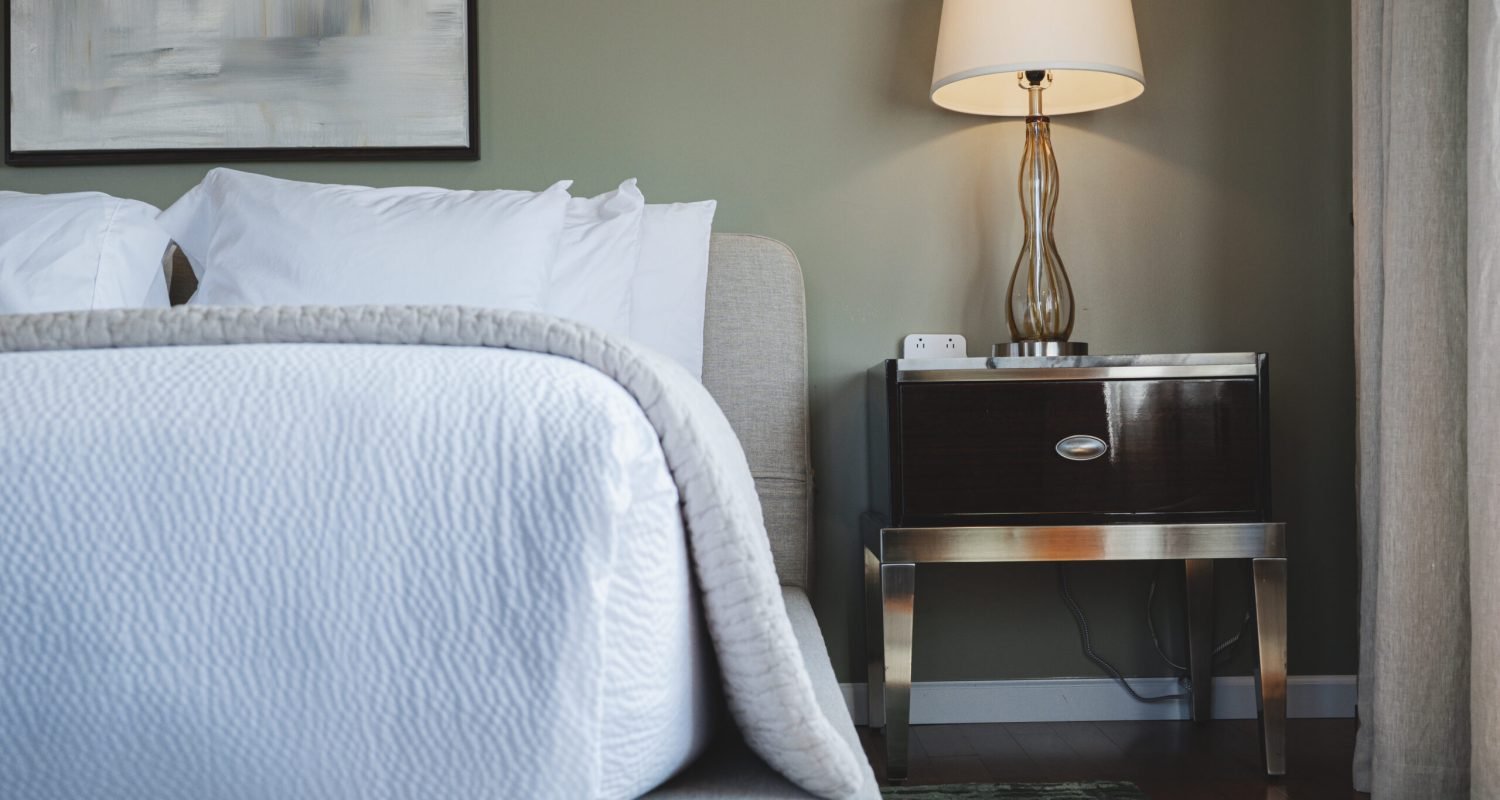 the-ford-suite-nightstand-close-up-with-glass-lamp-and-modern-artwork-powerhouse-on-broadway the-ford-suite-nightstand-close-up-with-glass-lamp-and-modern-artwork-powerhouse-on-broadway