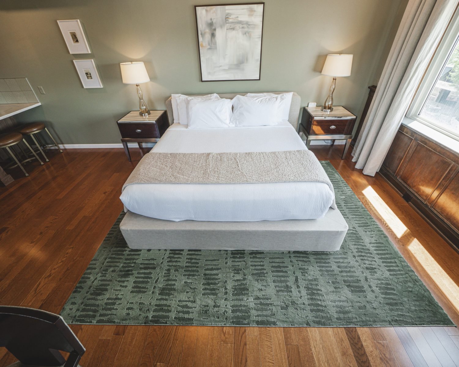 the-ford-suite-soft-green-walls-king-bed-two-nightstands-artwork-window-light-powerhouse-on-broadway